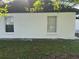 Side view of the house showcasing freshly painted walls at 641 Bayport Dr, Kissimmee, FL 34758