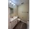 Updated bathroom with white vanity and bathtub/shower combo at 641 Bayport Dr, Kissimmee, FL 34758