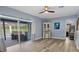 Bright bedroom with king-size bed, dark wood floors and access to backyard at 11209 Crescent Bay Blvd, Clermont, FL 34711