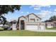 Two-story house with a three-car garage and American flag at 11209 Crescent Bay Blvd, Clermont, FL 34711