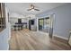 Bright living room with hardwood floors and view of the kitchen and pool at 11209 Crescent Bay Blvd, Clermont, FL 34711