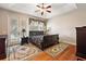 Main bedroom with hardwood floors, ceiling fan, and private balcony at 212 Crestrun Loop, Leesburg, FL 34748