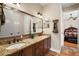 Double vanity bathroom with granite countertops and a view of the bedroom at 212 Crestrun Loop, Leesburg, FL 34748