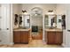 Double vanity bathroom with granite countertops and ample storage at 212 Crestrun Loop, Leesburg, FL 34748