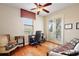 Home office with hardwood floors, built-in shelving, and access to a balcony at 212 Crestrun Loop, Leesburg, FL 34748