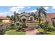 Two-story house with a brick driveway and nicely landscaped lawn at 212 Crestrun Loop, Leesburg, FL 34748