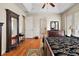 Spacious main bedroom with hardwood floors and ensuite bathroom access at 212 Crestrun Loop, Leesburg, FL 34748
