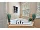 Relax in this luxurious corner jacuzzi tub, complete with modern fixtures at 212 Crestrun Loop, Leesburg, FL 34748