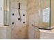 Spa-like shower with multiple shower heads and glass enclosure at 212 Crestrun Loop, Leesburg, FL 34748