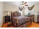 Spacious bedroom with ornate bed frame and window treatments at 212 Crestrun Loop, Leesburg, FL 34748