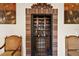 Elegant wine cellar with brick walls and wrought iron gate at 212 Crestrun Loop, Leesburg, FL 34748