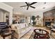 Open living area with a stone fireplace and comfortable seating at 212 Crestrun Loop, Leesburg, FL 34748
