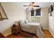 Bright bedroom with hardwood floors, a ceiling fan and ample natural light at 212 Crestrun Loop, Leesburg, FL 34748