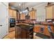 Island kitchen features granite countertops and stainless steel appliances at 212 Crestrun Loop, Leesburg, FL 34748