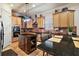 Updated kitchen featuring granite island and wood cabinets at 212 Crestrun Loop, Leesburg, FL 34748