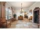 Elegant dining room with chandelier and built-in wine cellar at 212 Crestrun Loop, Leesburg, FL 34748