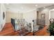 Upstairs hall with hardwood floors and wrought iron railing at 212 Crestrun Loop, Leesburg, FL 34748
