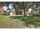 House with large backyard, and green lawn at 212 Crestrun Loop, Leesburg, FL 34748