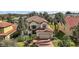 Two-story house with tile roof, two-car garage, and landscaped yard at 212 Crestrun Loop, Leesburg, FL 34748