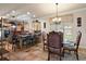 Kitchen and dining area with wood cabinets and a chandelier at 212 Crestrun Loop, Leesburg, FL 34748