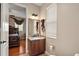 Single vanity bathroom with granite countertop and a view to the bedroom at 212 Crestrun Loop, Leesburg, FL 34748