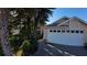 Exterior view of house with two-car garage and landscaping at 2939 Falling Tree Cir, Orlando, FL 32837