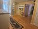 Bright hallway with hardwood floors, built-in shelving and storage at 14902 Arrena Rd, Winter Garden, FL 34787