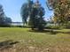 Peaceful backyard scene with a lake view and green grass at 14902 Arrena Rd, Winter Garden, FL 34787