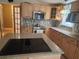 Kitchen with granite countertops, ample cabinetry, and island cooktop at 14902 Arrena Rd, Winter Garden, FL 34787