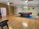 Spacious game room with hardwood floors and a pool table at 14902 Arrena Rd, Winter Garden, FL 34787