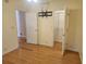 Bright bedroom with hardwood floors, spacious closet, and access to another room at 14902 Arrena Rd, Winter Garden, FL 34787