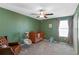 Bedroom with crib, rocker, and ample natural light at 3519 Lounging Wren Ln, Bartow, FL 33830