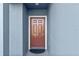 Modern front door with brown finish and doormat at 3519 Lounging Wren Ln, Bartow, FL 33830