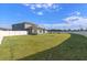 Large backyard with grassy area and white vinyl fence at 3519 Lounging Wren Ln, Bartow, FL 33830