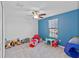 bedroom with toys and blue accent wall at 3519 Lounging Wren Ln, Bartow, FL 33830