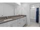 Bathroom with double vanity, granite countertop, and tub at 3519 Lounging Wren Ln, Bartow, FL 33830