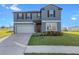 Two-story house with gray siding and landscaping at 3519 Lounging Wren Ln, Bartow, FL 33830