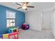 bedroom featuring a blue accent wall and play area at 3519 Lounging Wren Ln, Bartow, FL 33830