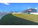 Spacious backyard with grassy area and white vinyl fence at 3519 Lounging Wren Ln, Bartow, FL 33830