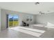 Bright living room with tile floors and sliding glass doors to backyard at 3519 Lounging Wren Ln, Bartow, FL 33830