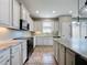 White kitchen cabinets, granite counters, and tile floors at 124 Bayou Bend Rd, Groveland, FL 34736