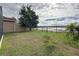 Spacious backyard with lake view and partial fence at 124 Bayou Bend Rd, Groveland, FL 34736