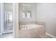 Relaxing bathroom with a soaking tub and access to a private patio at 4625 Target Blvd, Kissimmee, FL 34746
