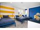 bedroom with three twin beds and yellow and blue walls at 4625 Target Blvd, Kissimmee, FL 34746