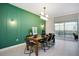 Elegant dining room with a wood table and modern chairs, near a pool at 4625 Target Blvd, Kissimmee, FL 34746