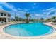 Community pool with lounge chairs and a large deck at 4625 Target Blvd, Kissimmee, FL 34746