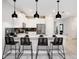 Modern kitchen with white cabinets, black accents, and breakfast bar with four stools at 4625 Target Blvd, Kissimmee, FL 34746