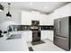 Modern kitchen with stainless steel appliances and white shaker cabinets at 4625 Target Blvd, Kissimmee, FL 34746