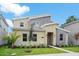 Two-story home with modern design, stone accents, and palm trees at 4625 Target Blvd, Kissimmee, FL 34746
