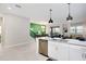 Open concept kitchen with island, stainless steel appliances, and green accent wall at 4625 Target Blvd, Kissimmee, FL 34746